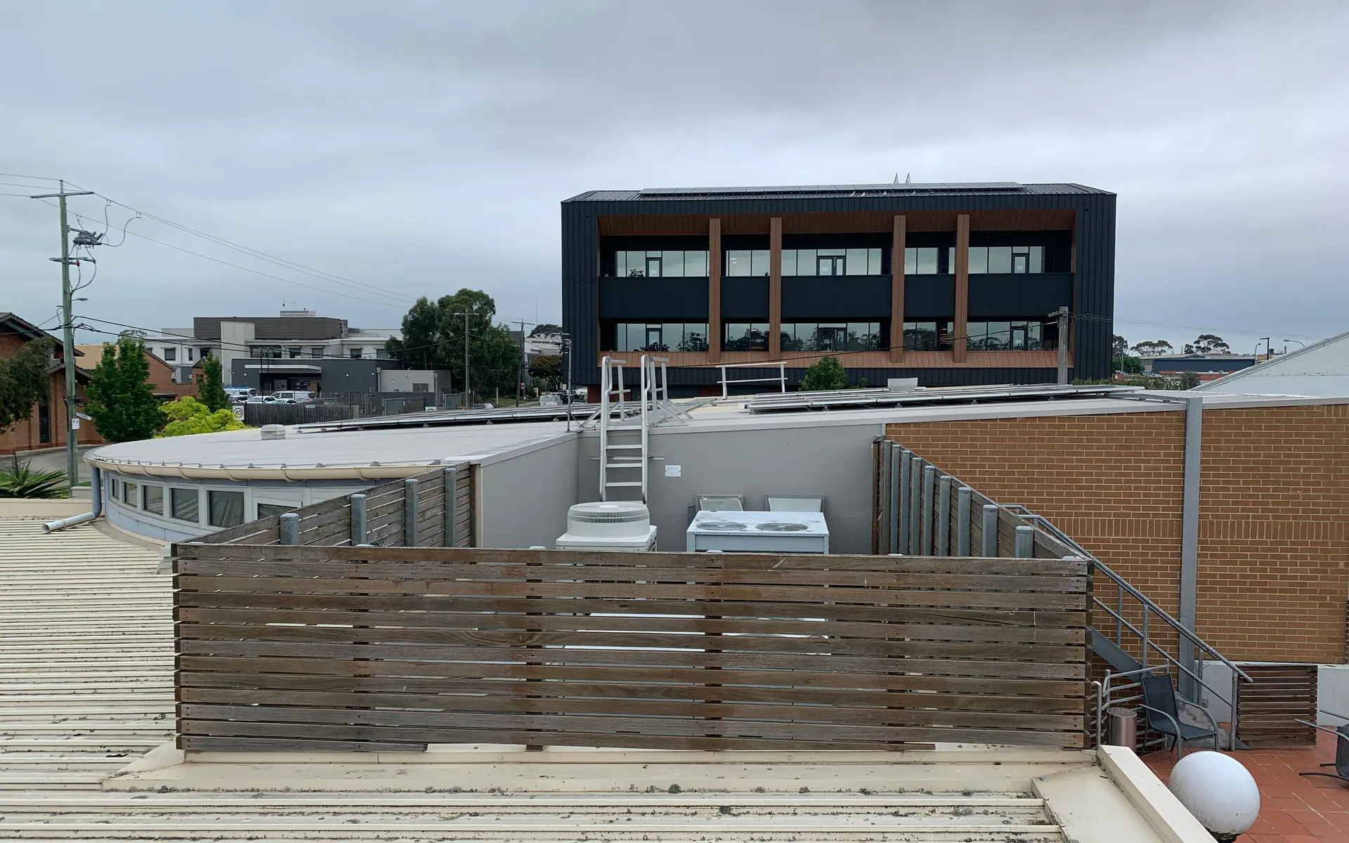 Commercial building with a metal roof and screening