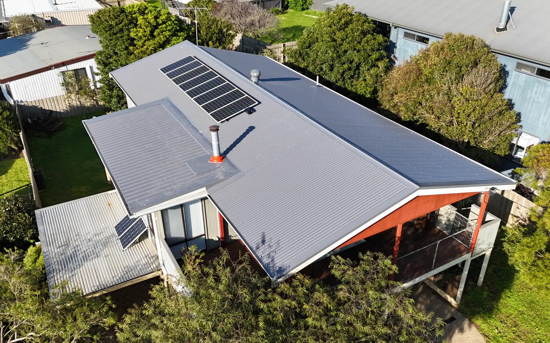 Dark metal roof with solar panels reinstated after re-roofing