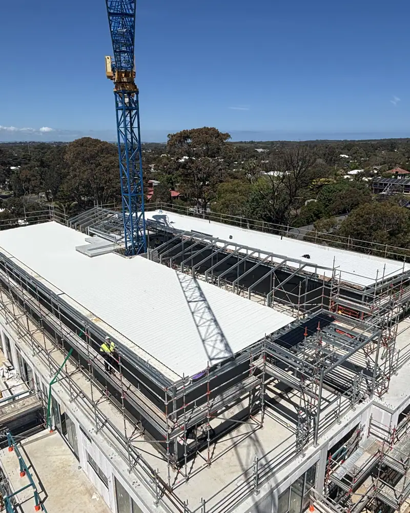 Large commercial metal roof nearing completion