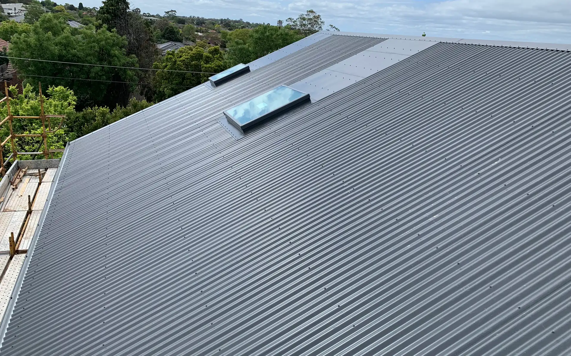 Replacement charcoal metal roof with a skylight on a Melbourne home