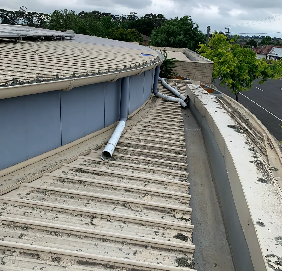 Commercial box gutter with debris and corrosion