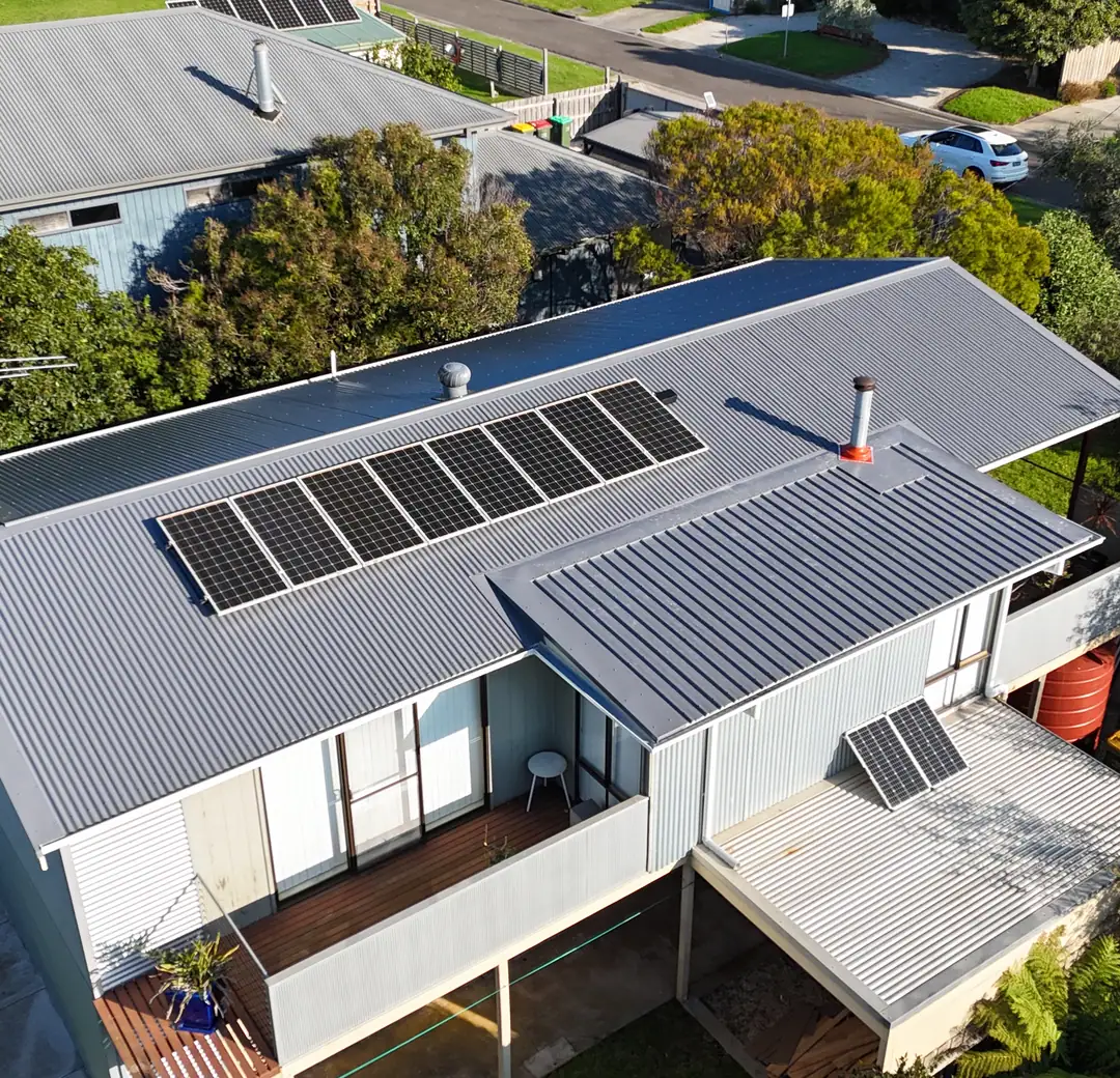 Metal roof with solar panels on a single storey home