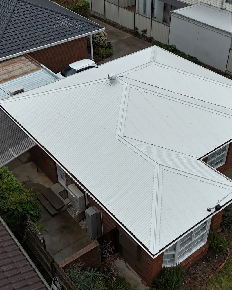 New metal roof on a brick home that previously had a tiled roof