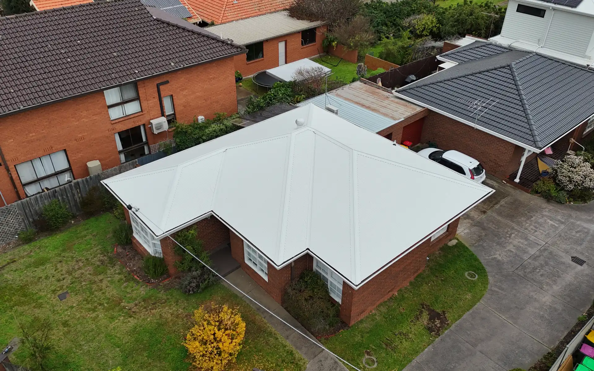 New metal roof on a brick home that previously had a tiled roof